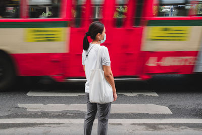 Full length of woman standing on street in city