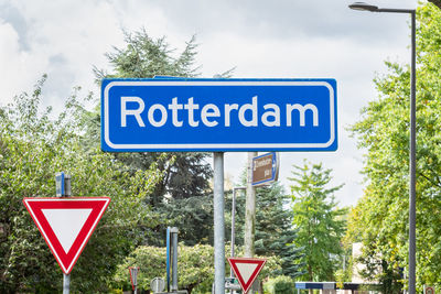 Road sign against trees