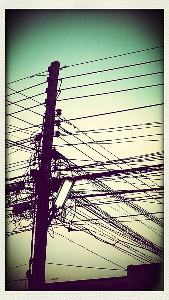 transfer print, auto post production filter, low angle view, sky, connection, built structure, silhouette, architecture, clear sky, protection, outdoors, pole, fence, no people, sunset, power line, sunlight, electricity pylon, day, safety