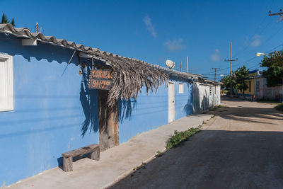 Road by building against sky