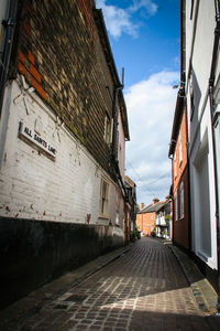 Empty alley amidst buildings in city