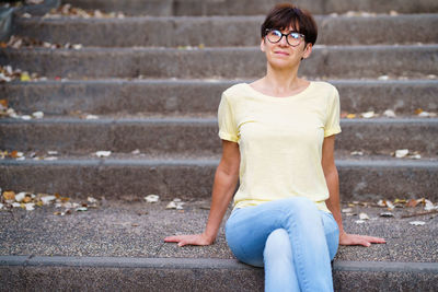 Young woman sitting on staircase