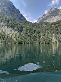 Scenic view of lake and mountains against sky