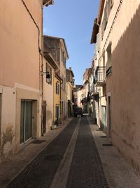 Alley amidst buildings against sky