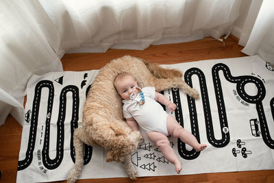 High angle view of baby lying down on bed