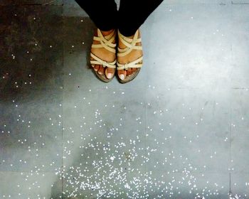 Low section of people standing on tiled floor