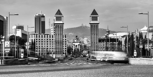 View of city street and buildings against sky