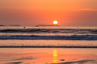 Scenic view of sea against romantic sky at sunset