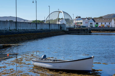 Boat moored on river against sky