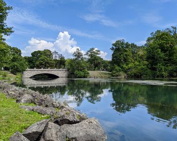 Arch bridge over lake against sky