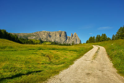 Road amidst mountain against clear sky