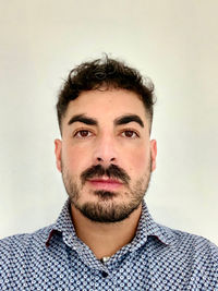 Portrait of young man against white background