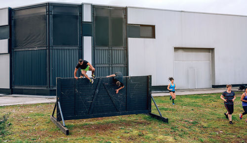 People playing outside building