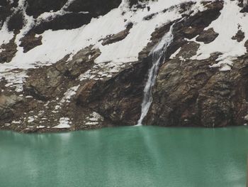 Scenic view of lake and snow covered mountain during winter