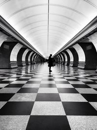 Rear view of man walking in corridor