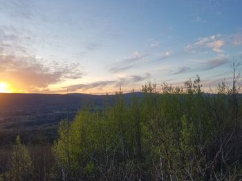 Scenic view of land against sky during sunset