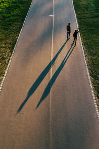 High angle view of men walking on road