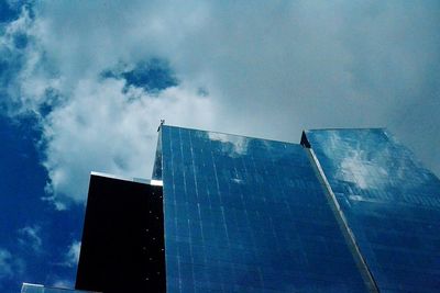 Low angle view of building against cloudy sky