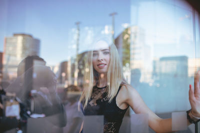 Reflection of woman in glass building