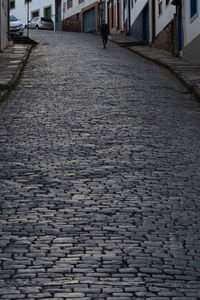 Surface level of cobblestone street in city