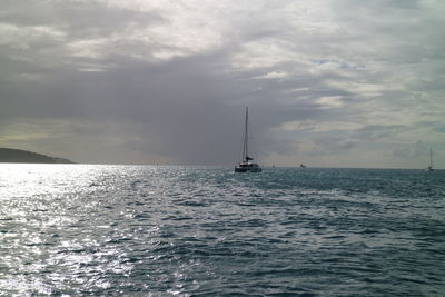 Sailboat sailing on sea against sky