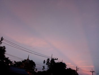 Low angle view of silhouette trees against sky