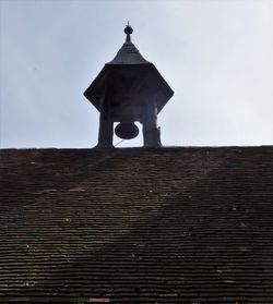 Low angle view of bell tower against sky