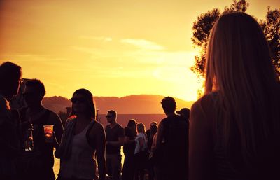 Silhouette of person in sea at sunset