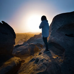 Man standing on rock looking at view