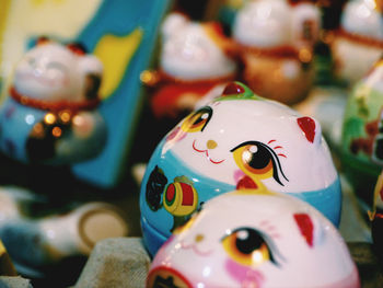 Close-up of multi colored maneki-neko figurines