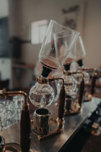 Close-up of wine glasses on table