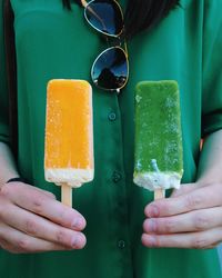 Midsection of woman holding flavored ices