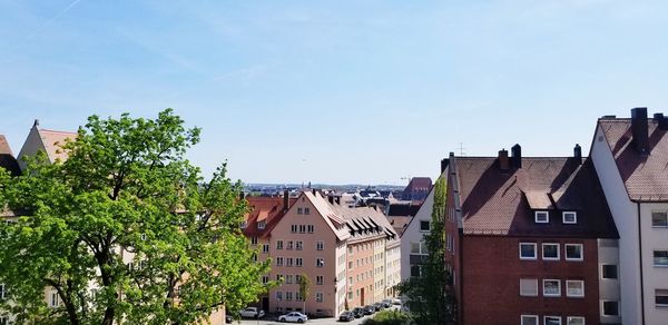 Buildings in town against blue sky