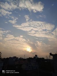 Silhouette buildings against sky during sunset