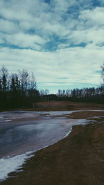 Scenic view of sea against cloudy sky