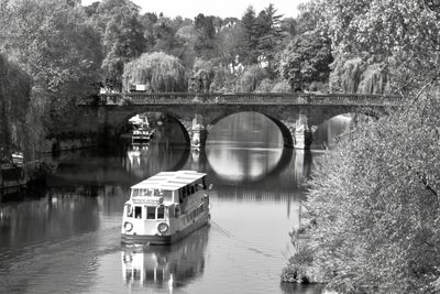 Arch bridge over river against sky