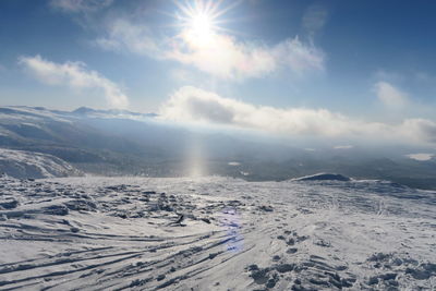 Scenic view of snow covered mountains against sky