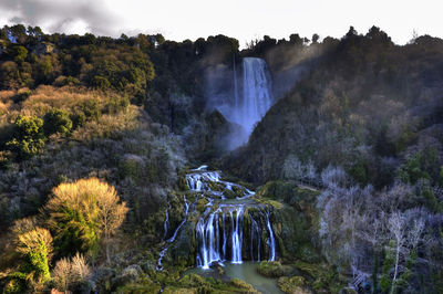 Panoramic view of waterfall in forest