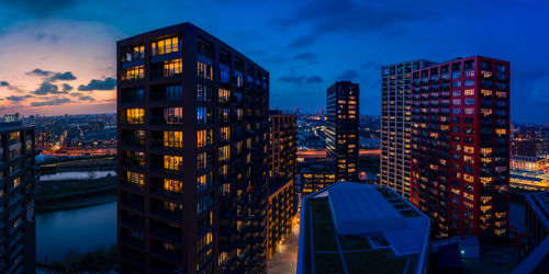 Illuminated buildings against sky at night