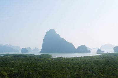 Scenic view of sea and mountains against clear sky