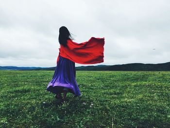Scenic view of field against cloudy sky