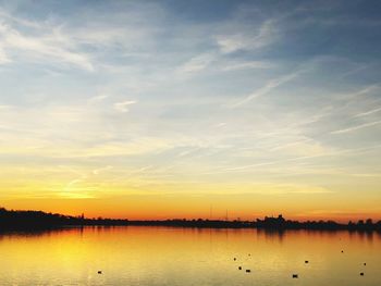 Scenic view of lake against sky during sunset