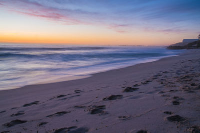 Scenic view of beach against sky during sunset