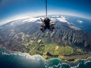 People paragliding over landscape