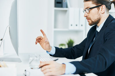 Midsection of man working with mobile phone