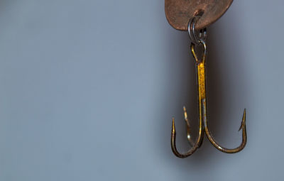 Close-up of chain hanging against wall