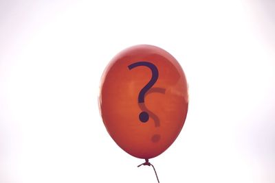 Close-up of red balloon against white background