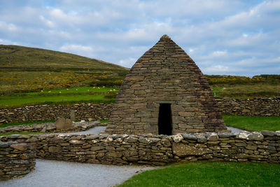 View of old ruin building against cloudy sky