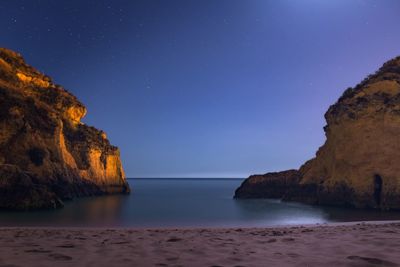 Scenic view of sea against clear sky at night