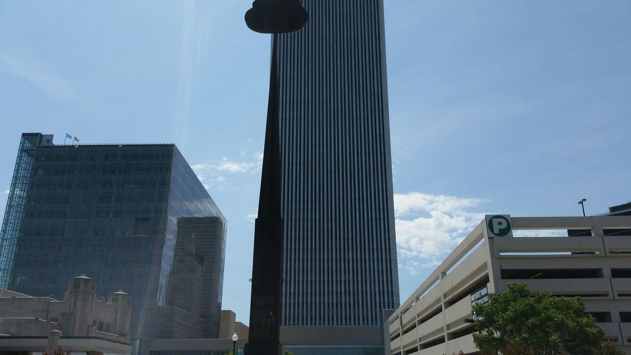 architecture, built structure, building exterior, low angle view, sky, city, modern, building, office building, tall - high, skyscraper, day, tower, outdoors, blue, sunlight, cloud - sky, window, city life, glass - material